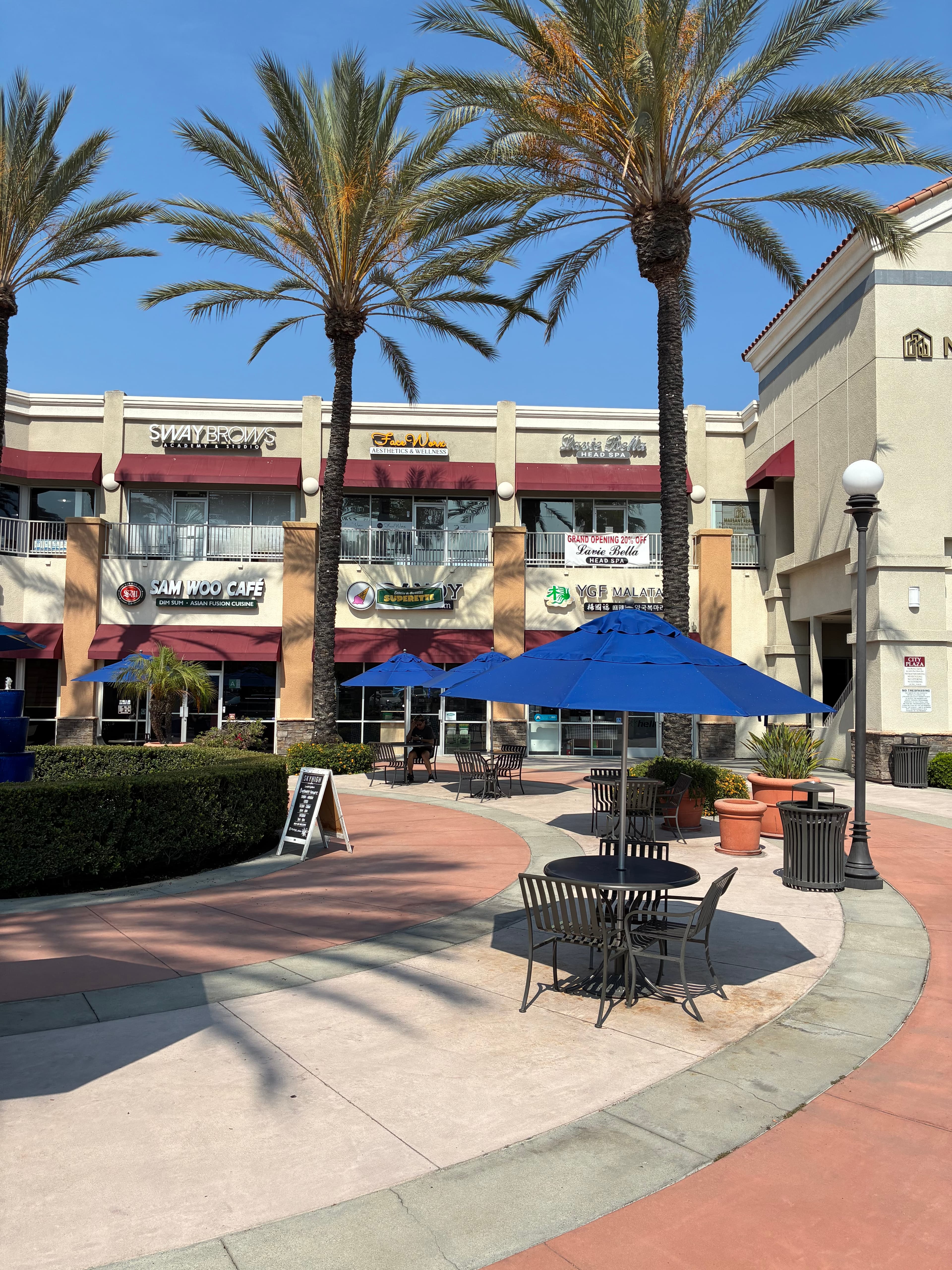 Artesia City Plaza exterior with palm trees β home to Lavie Bella Head Spa, La Tavolata, and more