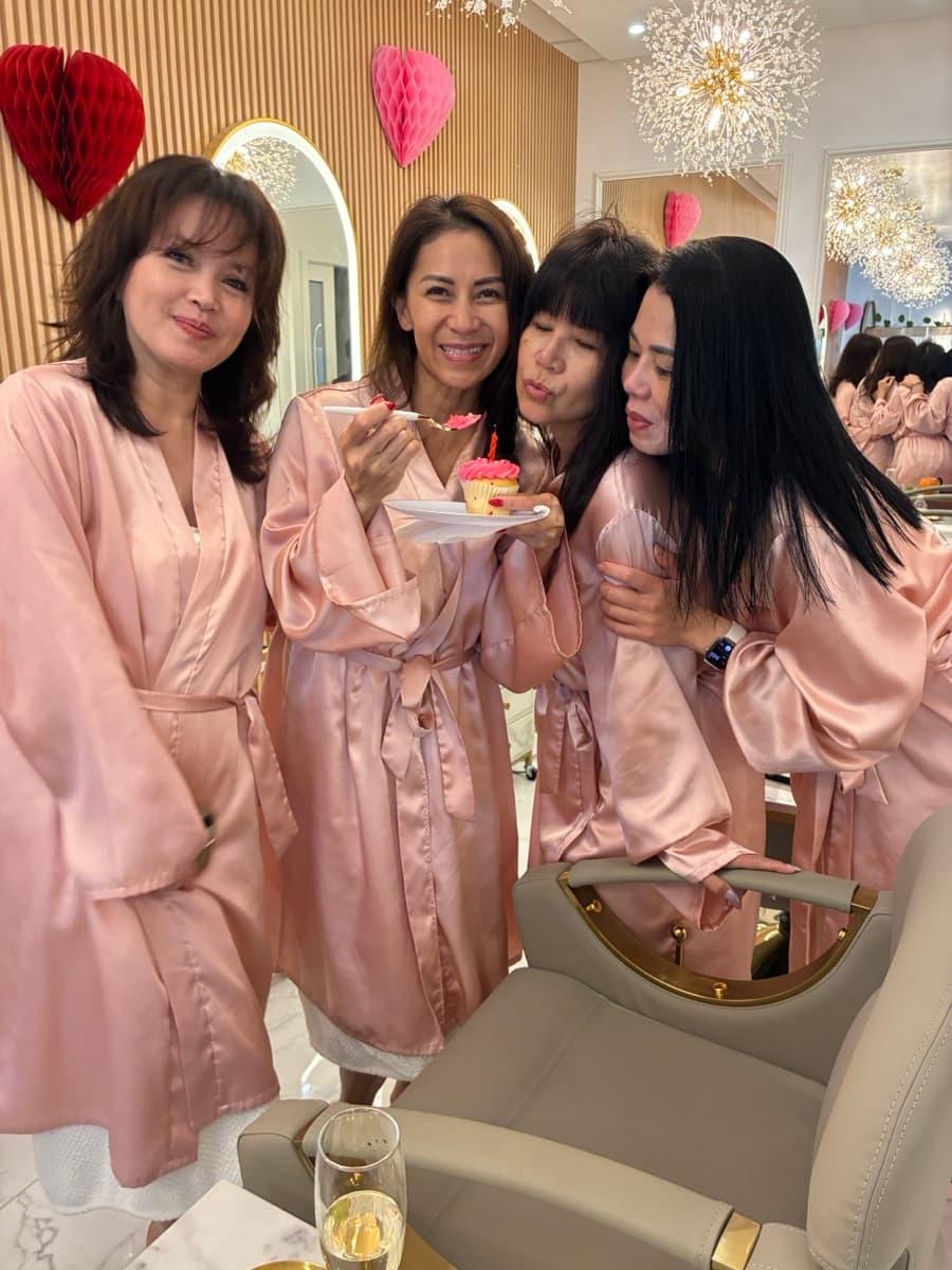 Birthday celebration group in pink robes